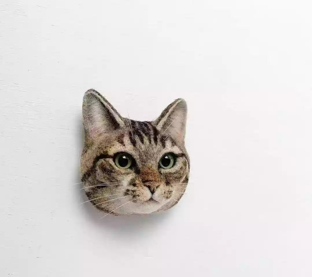 Custom 3D cat head replica mounted on a white background