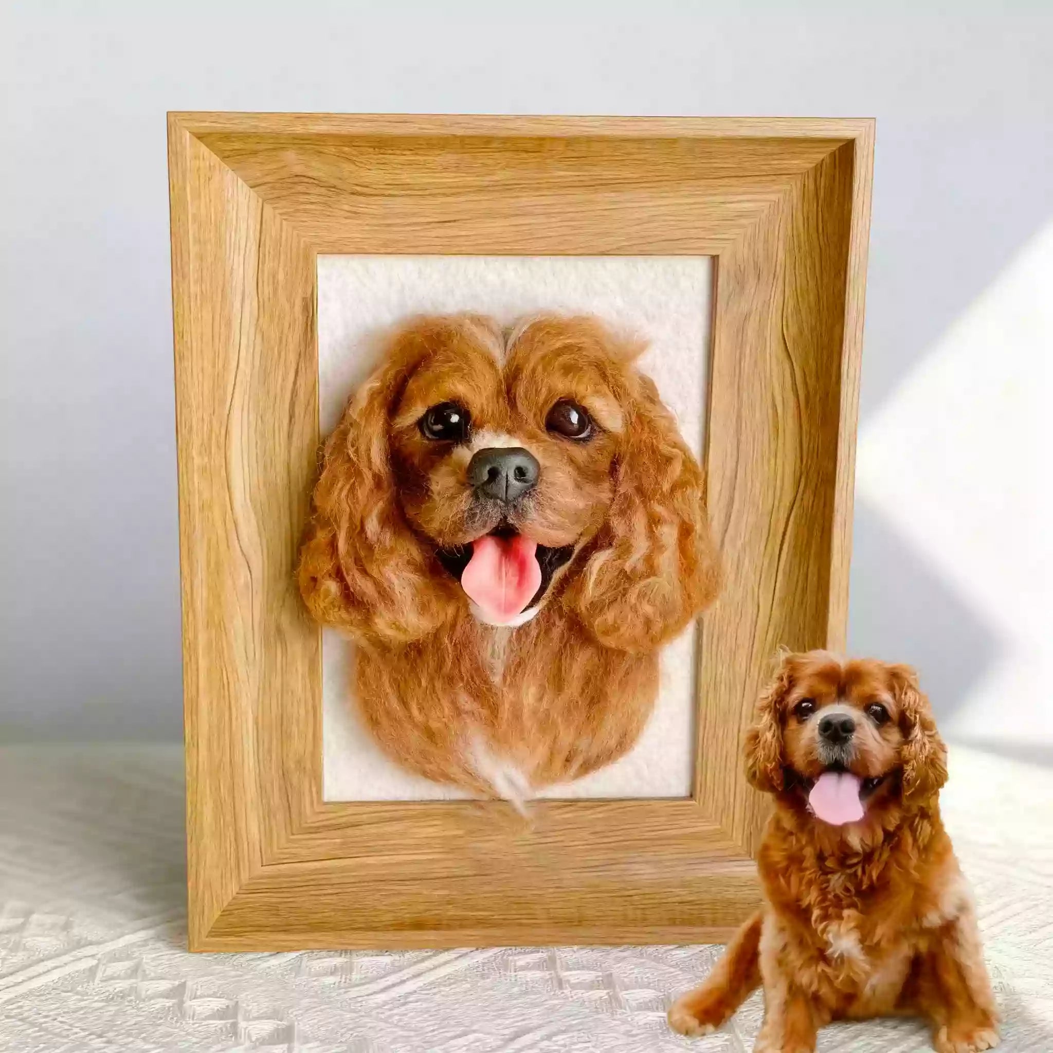 Personalized wool felt dog portrait in a wood picture frame displayed on a tabletop.
