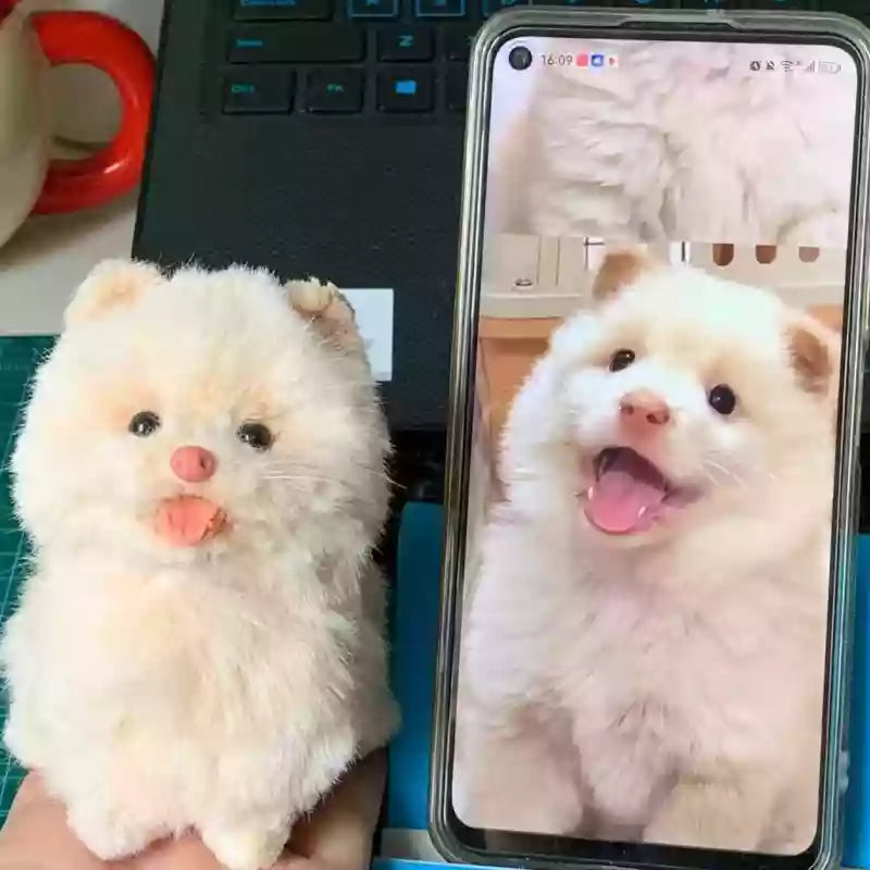 two custom 3D bendable pet figures shown with the photo reference on a phone
