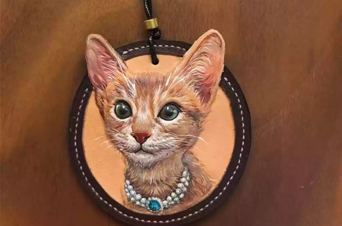 Finished custom leather pet portrait keychain with a cat design attached to a key ring
